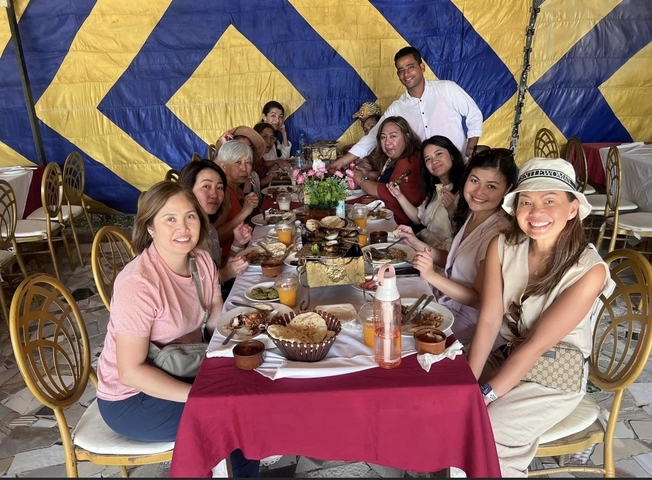       Group dining outdoors under a tent
  