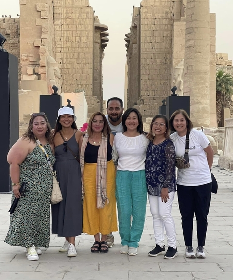       Group photo in front of ancient Egyptian ruins
  