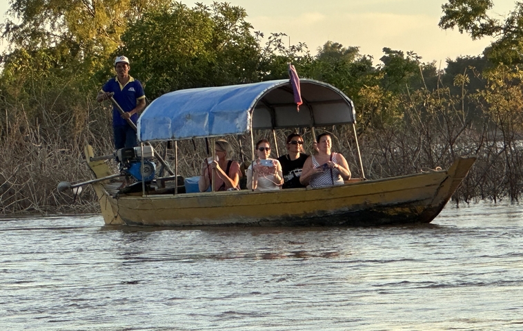       People on a boat ride in a river.
  