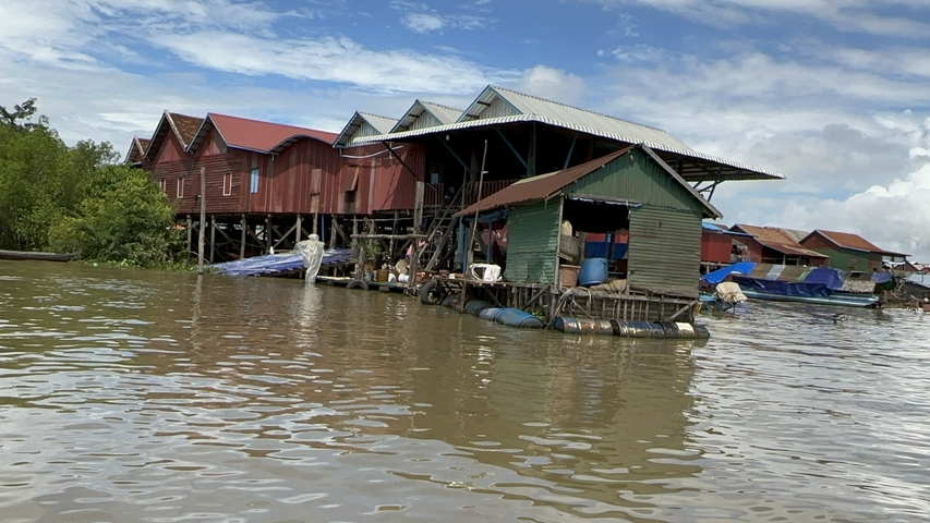       Row of stilt houses on a river.
  