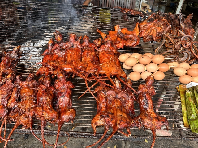       Grilled meats and eggs at a street market.
  