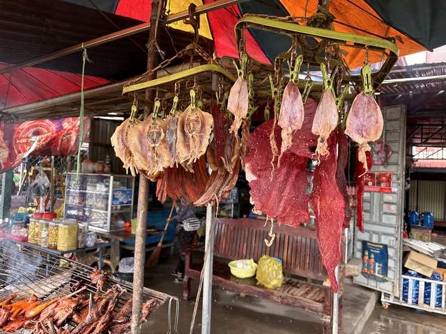       Dried meats hanging in a market stall.
  