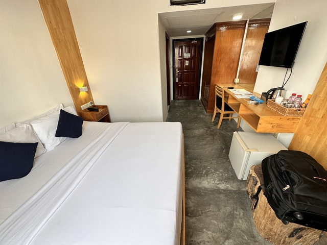       Hotel room interior with bed and desk
  