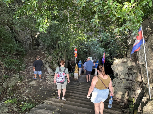       Group of people descending into a cave.
  