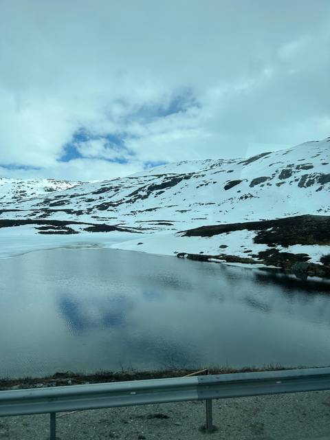 Snow-covered mountains by a lake.