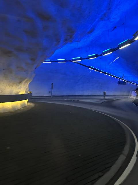 Tunnel illuminated with blue lights.