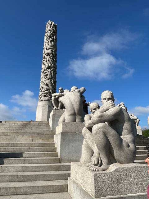 Statues in an outdoor park with a blue sky.