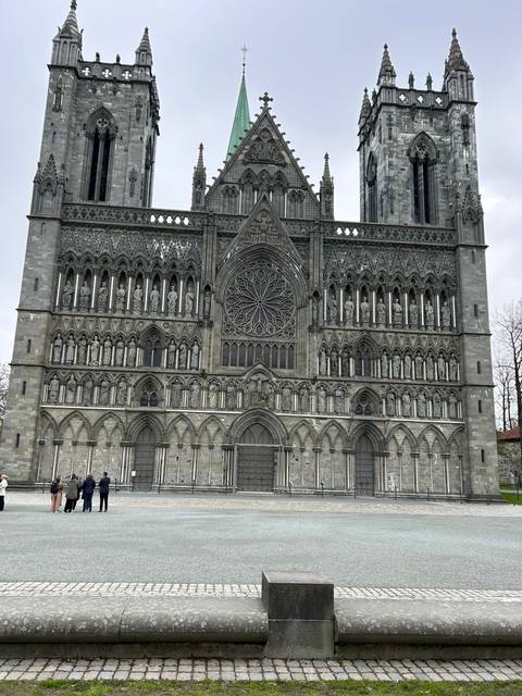 Ornate gothic-style building with people in the foreground.
