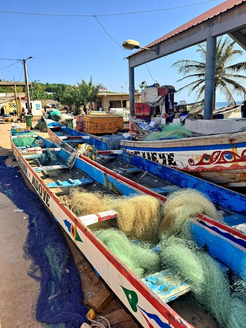 Colorful fishing boats with nets and supplies.