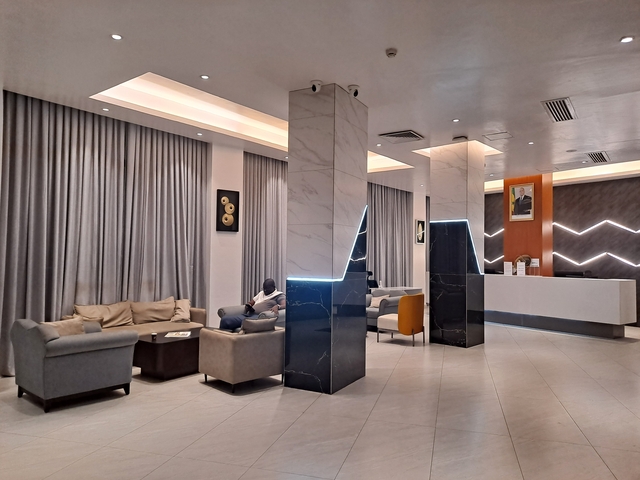 Modern hotel lobby with seating area and contemporary decor.