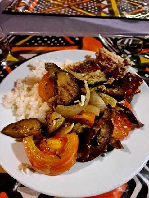       Plate of rice with vegetables and fish, prepared in a traditional style.
  