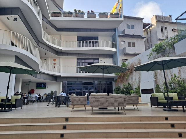       Modern courtyard with seating and umbrellas.
  