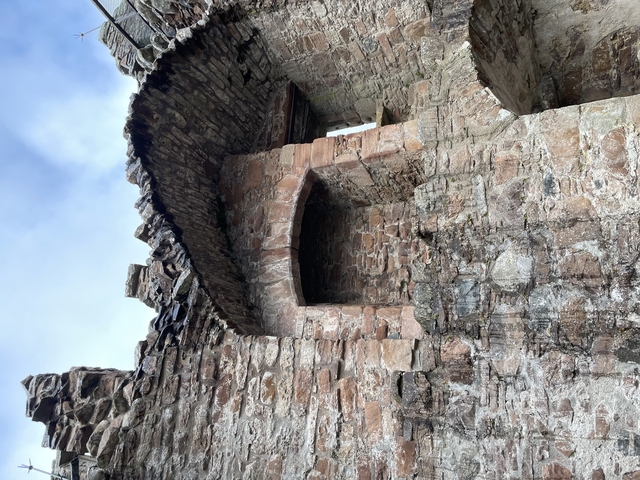       Ruins of a historic stone structure against a blue sky.
  