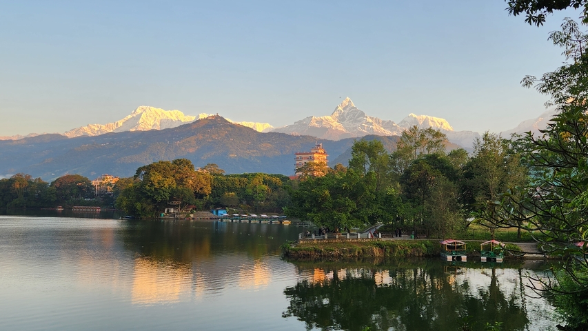       Lake with mountains in the background during sunset.
  