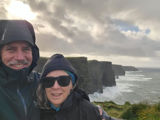 Couple posing with the Cliffs of Moher in the background.