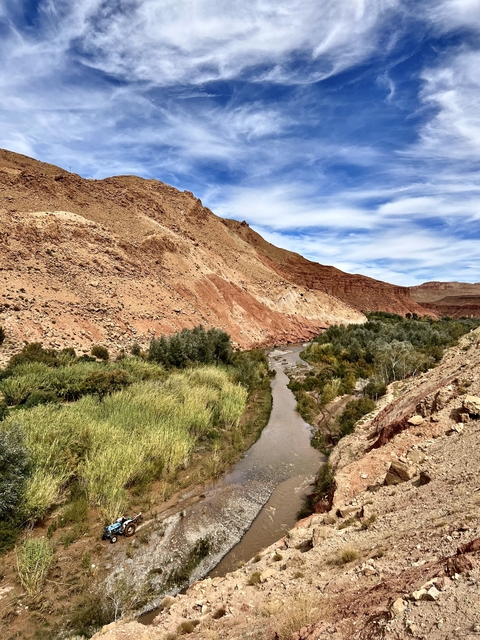 River flowing through a canyon with vegetation.
