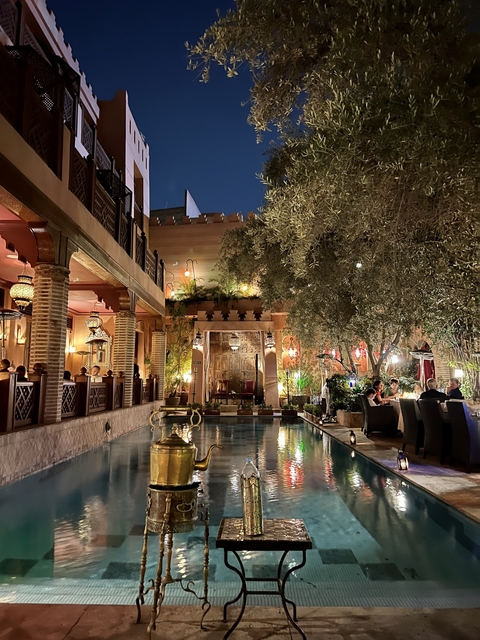       A beautifully decorated courtyard with an outdoor dining area.
  