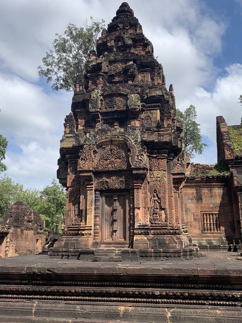 Banteay Srei, a richly decorated temple with detailed stone carvings.