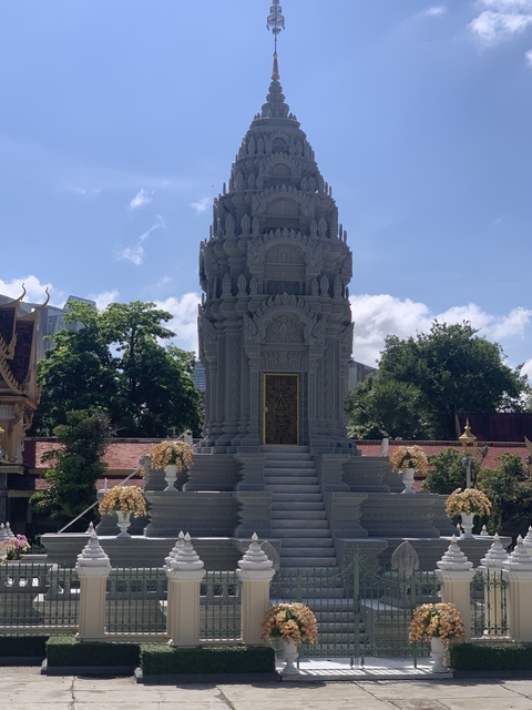       An elegant monument with detailed carvings and a serene setting.
  