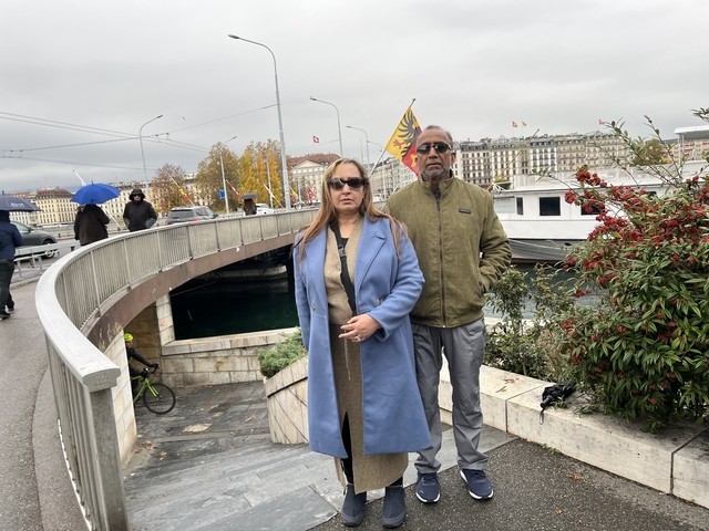 Two people posing near a large waterway in Geneva.