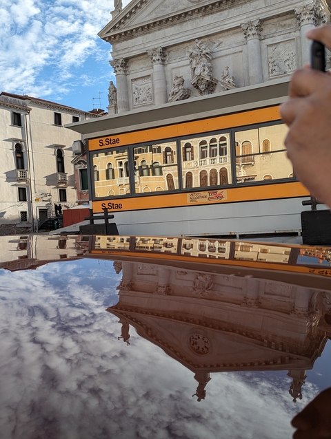 Venetian water bus reflected on the surface.