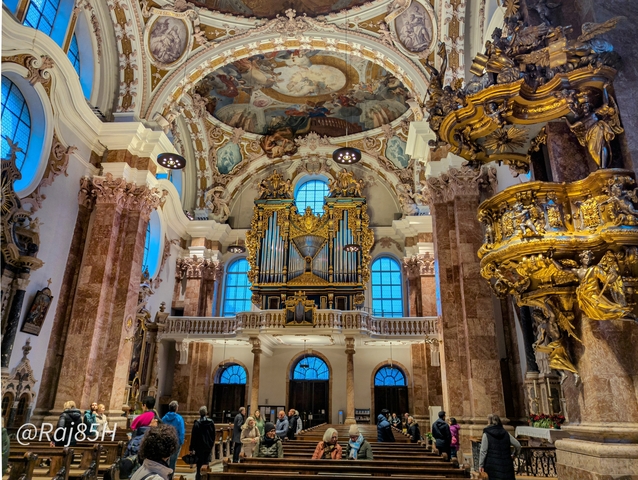 Interior of a grand church with an ornate organ.