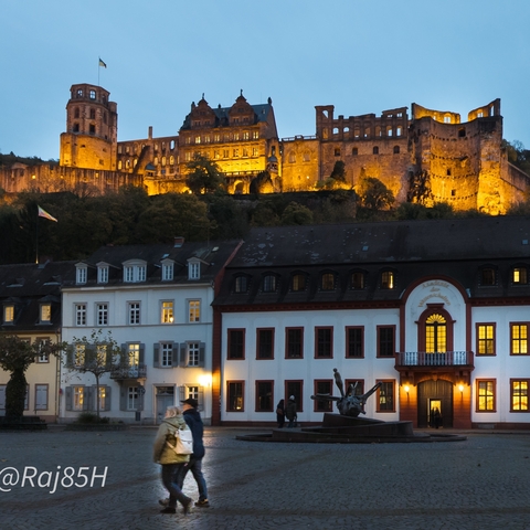 Illuminated Heidelberg Castle seen from the town below.