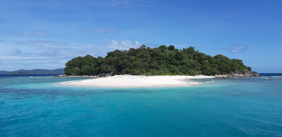 Pristine island with white sand and turquoise water.