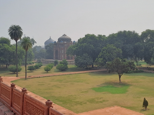 Lush green garden surrounding a domed structure.