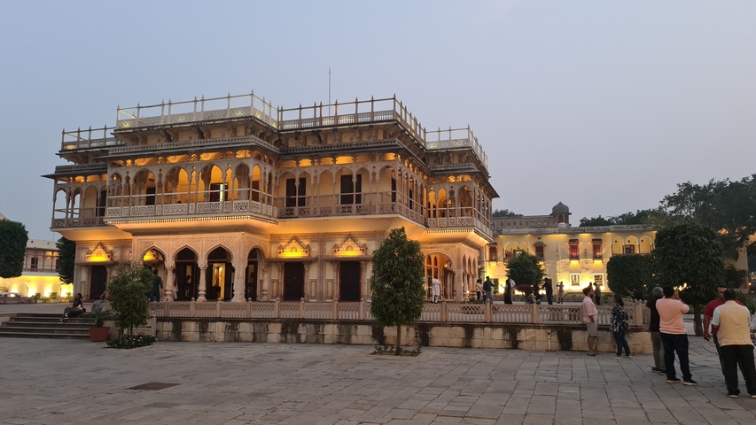 An illuminated historical building at dusk.