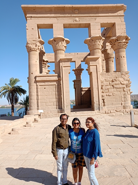 A group standing before an ancient temple.