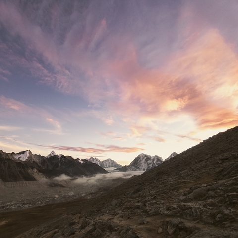 A stunning view of mountains at sunrise with vibrant sky.