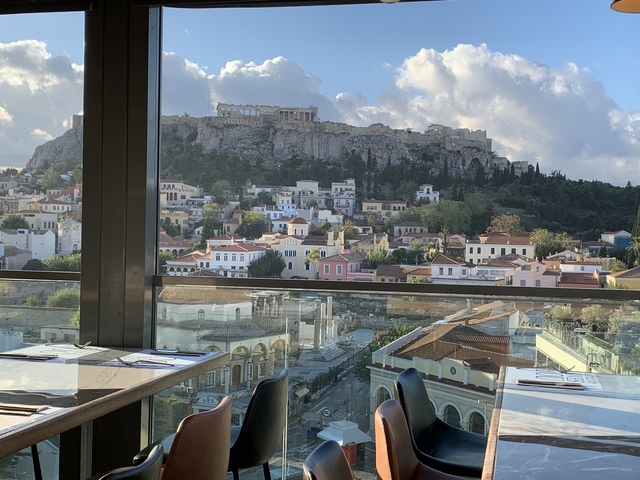       View of the Acropolis from a restaurant window.
  