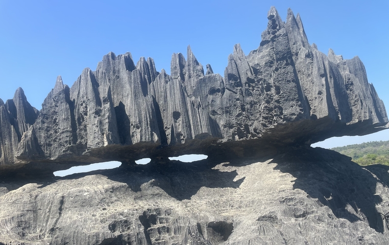 Unique rock formations under a blue sky.