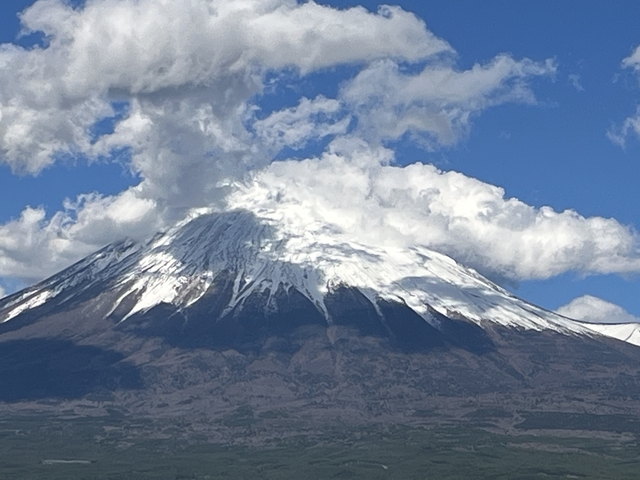       Snow-capped mountain peak with clouds in the sky.
  