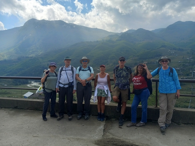 Group of tourists with mountain landscape in the background.