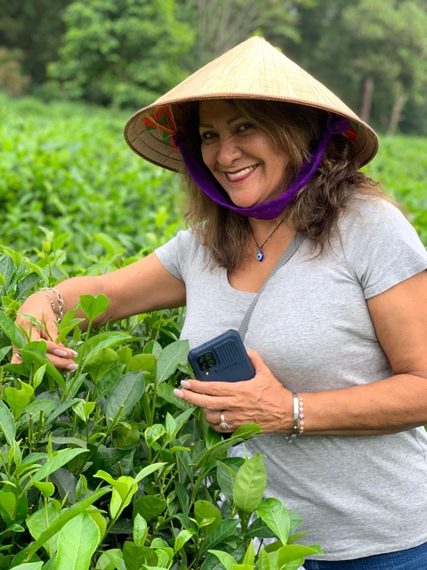 Close-up of a woman examining plants.