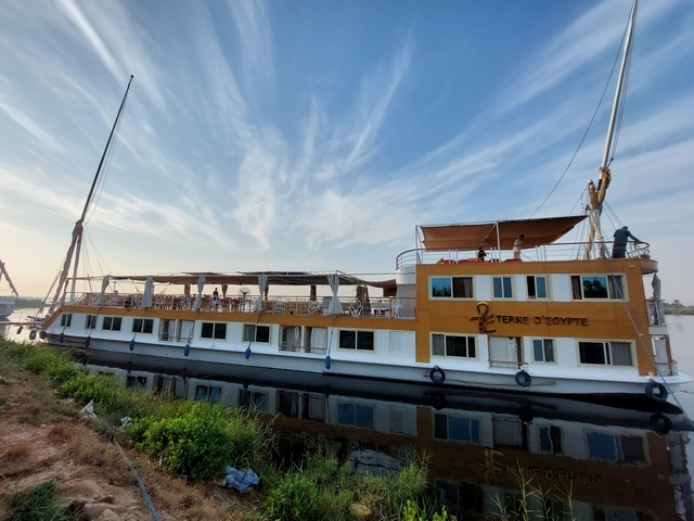 Nile River cruise boat docked by the riverside.