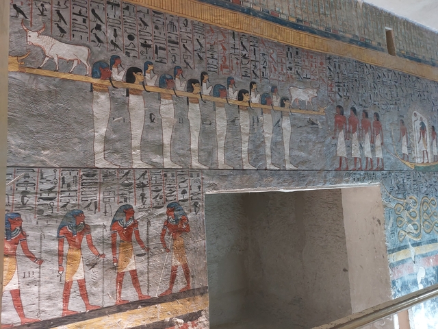 Colorful hieroglyphics on an ancient Egyptian tomb wall.