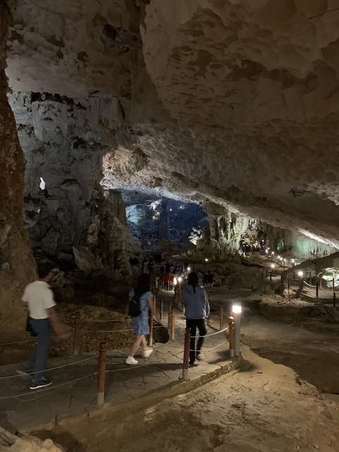 People exploring the inside of a large cave.