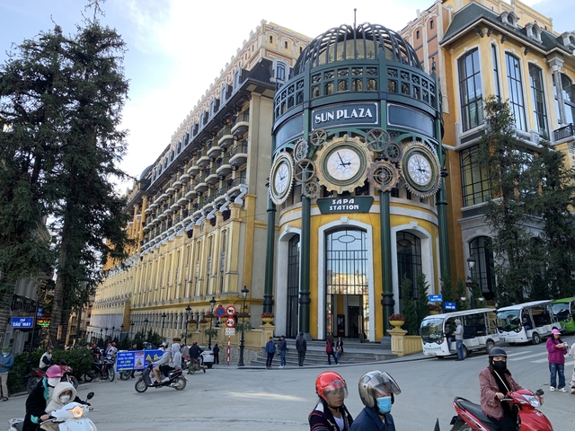       Decorative building facade with large clocks in an urban area.
  