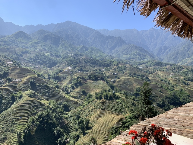 Wide view of terraced fields and a mountainous landscape.