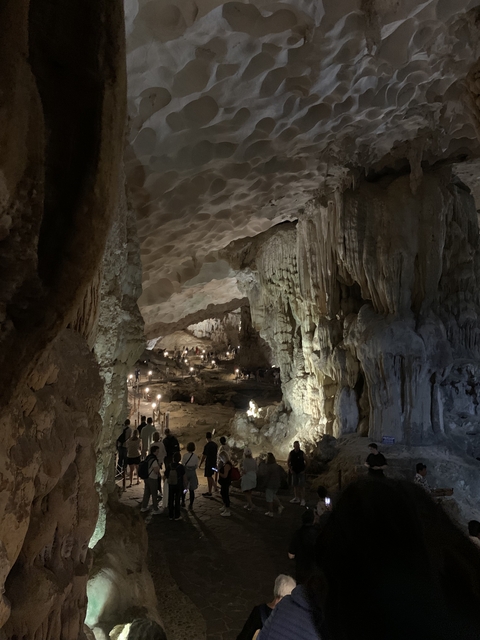       Cave interior with many visitors.
  