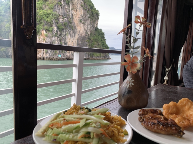 Dining with a view of the bay and food on the table.