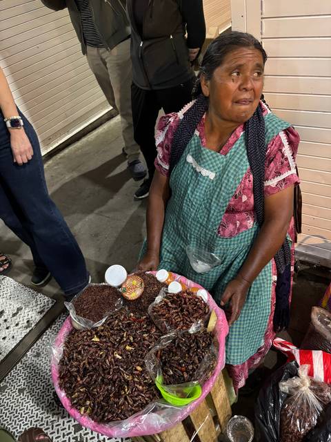 Woman selling traditional food in a market.