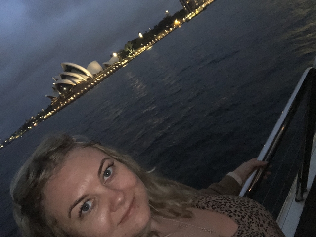       Person on a boat with night view of the Sydney Opera House
  