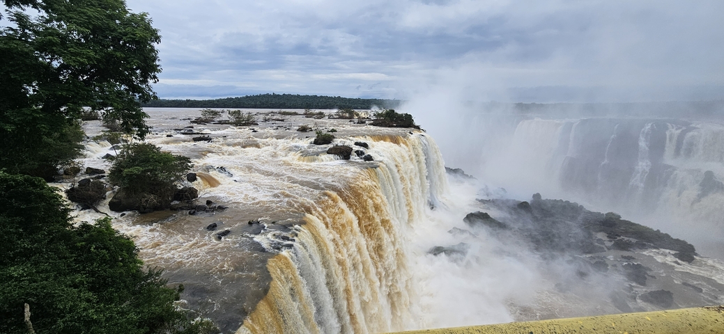 Majestic waterfalls cascading into a rapid river.