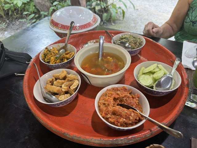 Variety of Thai dishes served on a red tray.