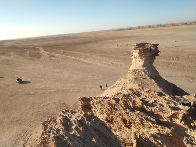 Desert landscape with rocky formation.
