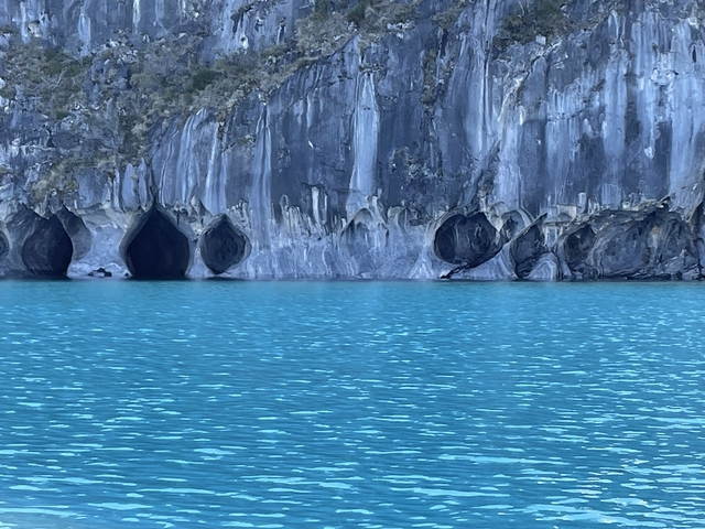Rock formations emerging from a turquoise lake.